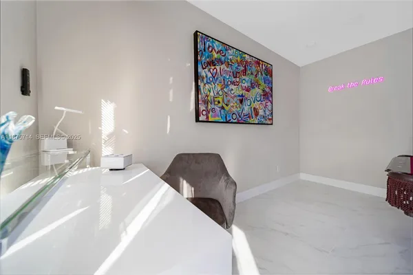 a bedroom with a bed and a painting on the wall