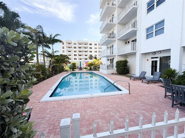 a swimming pool with outdoor seating and yard