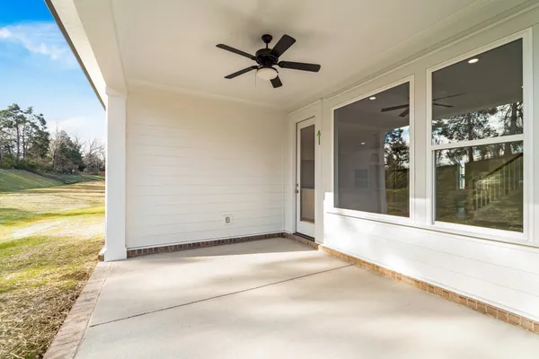 a view of a livingroom with a ceiling fan and window