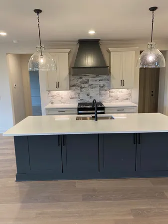 a kitchen with a cabinets and chandelier