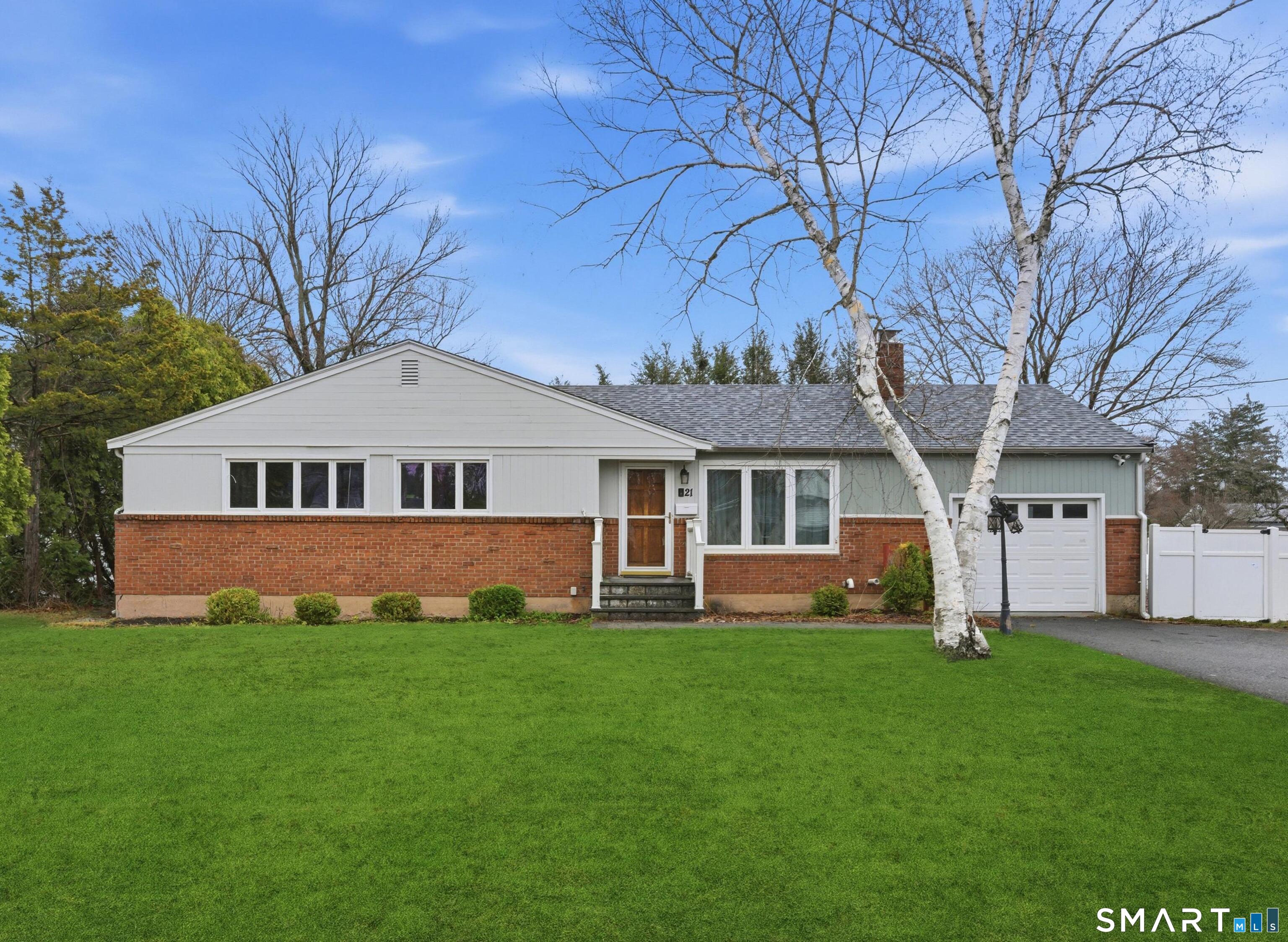 Front of the home. Grass has been digitally enhanced.