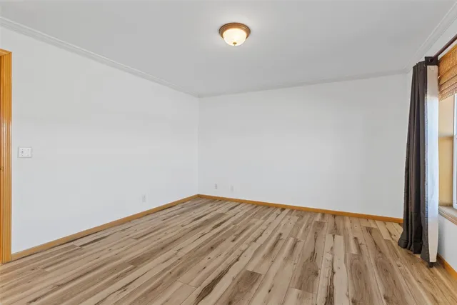 a view of an empty room and wooden floor