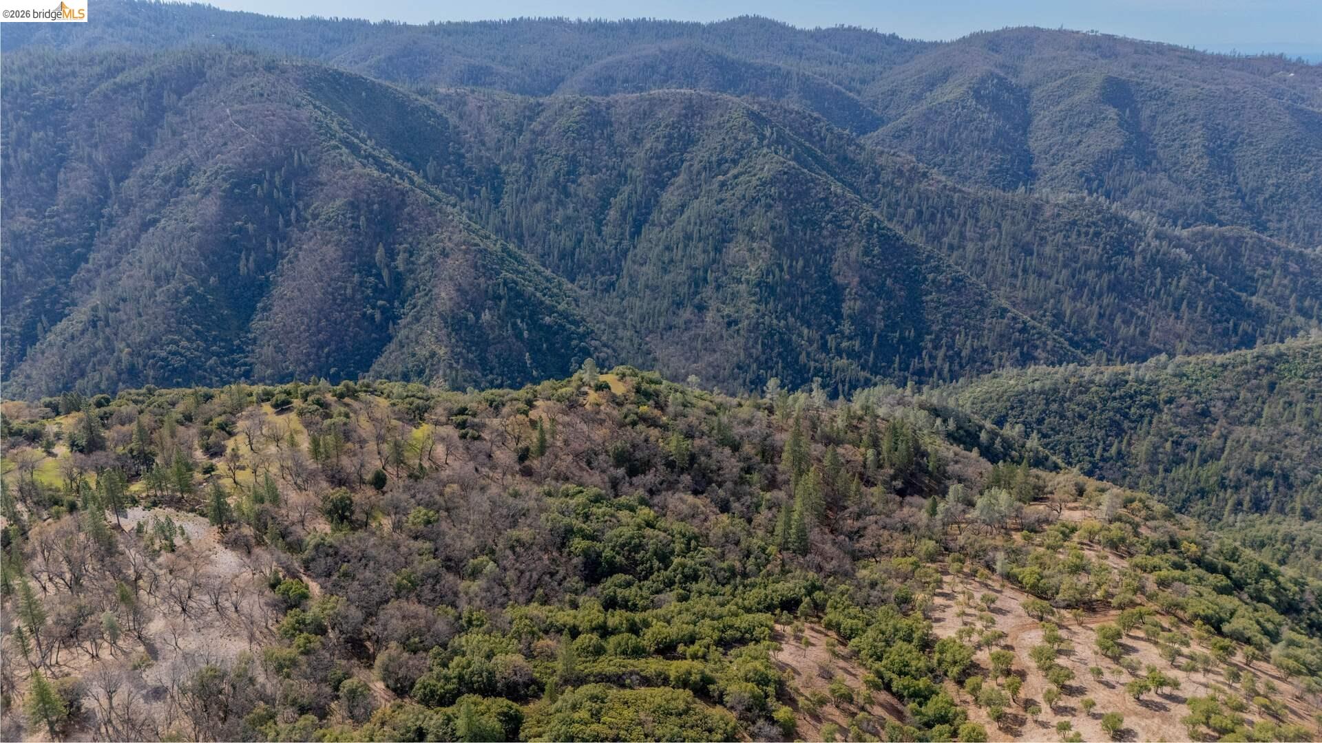 25555 Forest Rte 3N11 Columbia, CA 95310 - Photo 10 of 11 a view of a dry field with mountains in the background