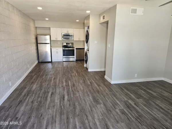 a view of kitchen view wooden floors appliances and cabinets