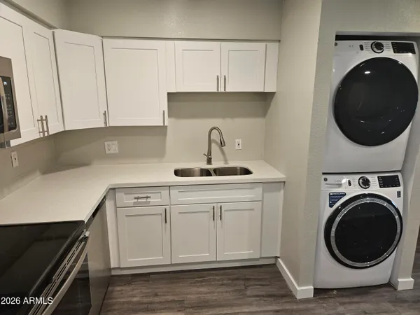a kitchen with a sink and a stove top oven
