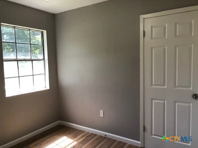 a view of hallway with wooden floor