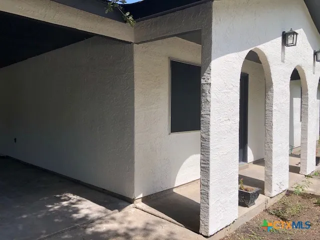 a kitchen with stainless steel appliances kitchen island granite countertop a stove a sink and white cabinets