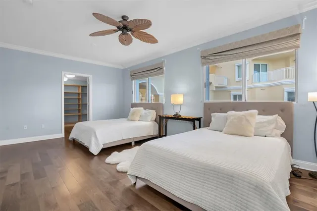 a bedroom with a bed and a large mirror