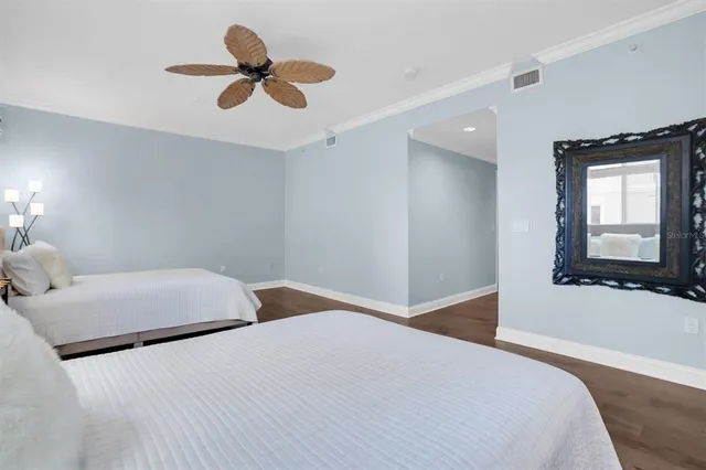 a bedroom with a bed furniture and a large window