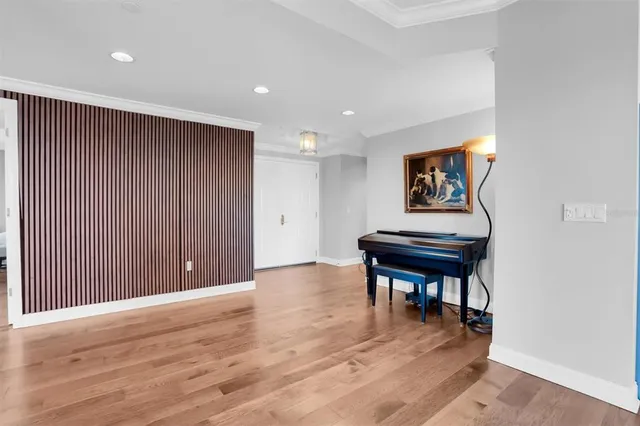 a view of a livingroom with furniture a dinning room and wooden floor