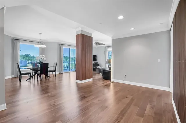 a dining room with furniture a chandelier and wooden floor