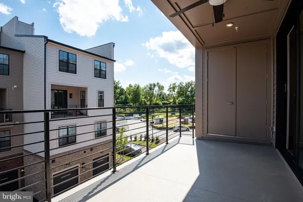 a view of a big room with wooden floor and windows