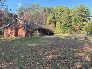 a view of an house with backyard space and garden