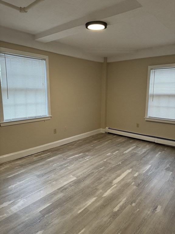 52 Washington Street, Unit 9 Marblehead, MA 01945 - Photo 11 of 17 a view of an empty room with wooden floor and a window