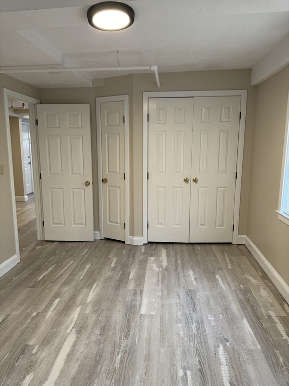 52 Washington Street, Unit 9 Marblehead, MA 01945 - Photo 12 of 17 a view of a livingroom with wooden floor and closet