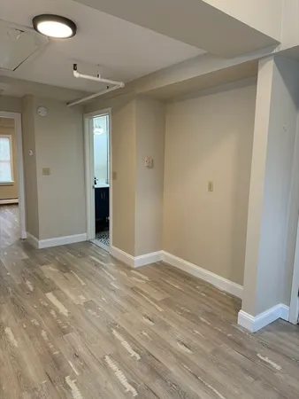 a view of an empty room and wooden floor