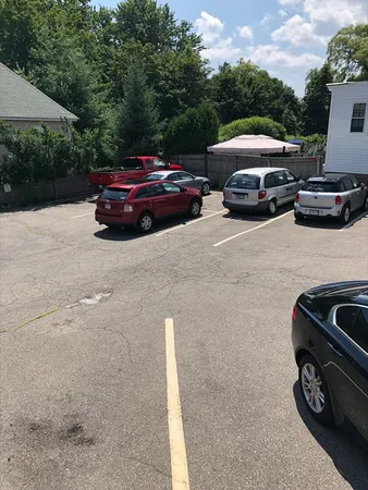 a front view of a house with parking space