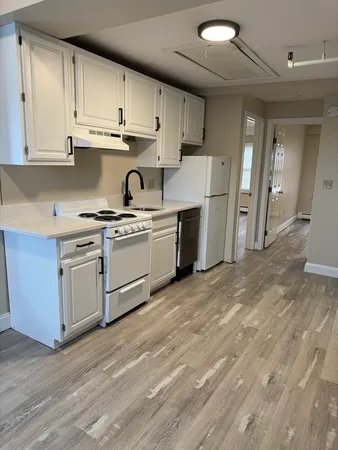 a kitchen with stainless steel appliances granite countertop a stove a sink dishwasher and a refrigerator