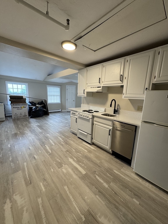 52 Washington Street, Unit 9 Marblehead, MA 01945 - Photo 3 of 17 a kitchen with a sink a stove and cabinets