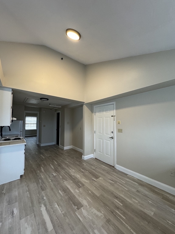 52 Washington Street, Unit 9 Marblehead, MA 01945 - Photo 4 of 17 a view of a livingroom with wooden floor and kitchen space