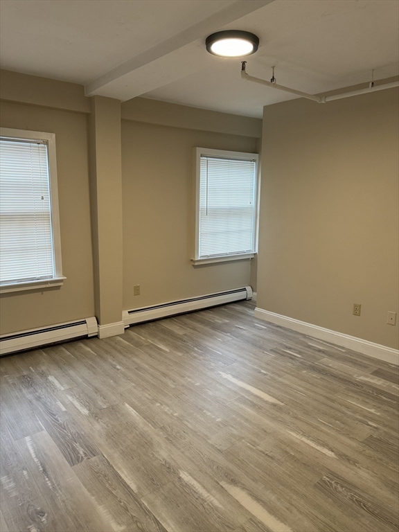 52 Washington Street, Unit 9 Marblehead, MA 01945 - Photo 10 of 17 an empty room with wooden floor and windows