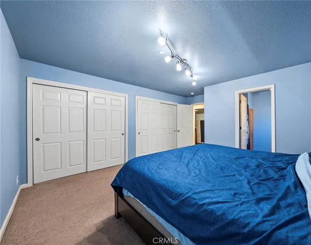 a bed room with a bed and a mirror