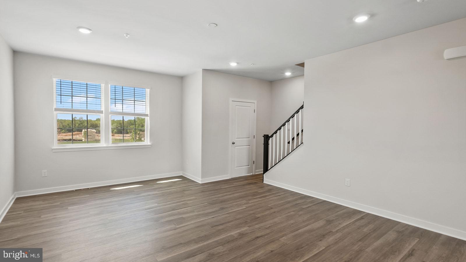 7507 Silver Thread Way Brandywine, MD 20613 - Photo 8 of 27 a view of an empty room with wooden floor and a window