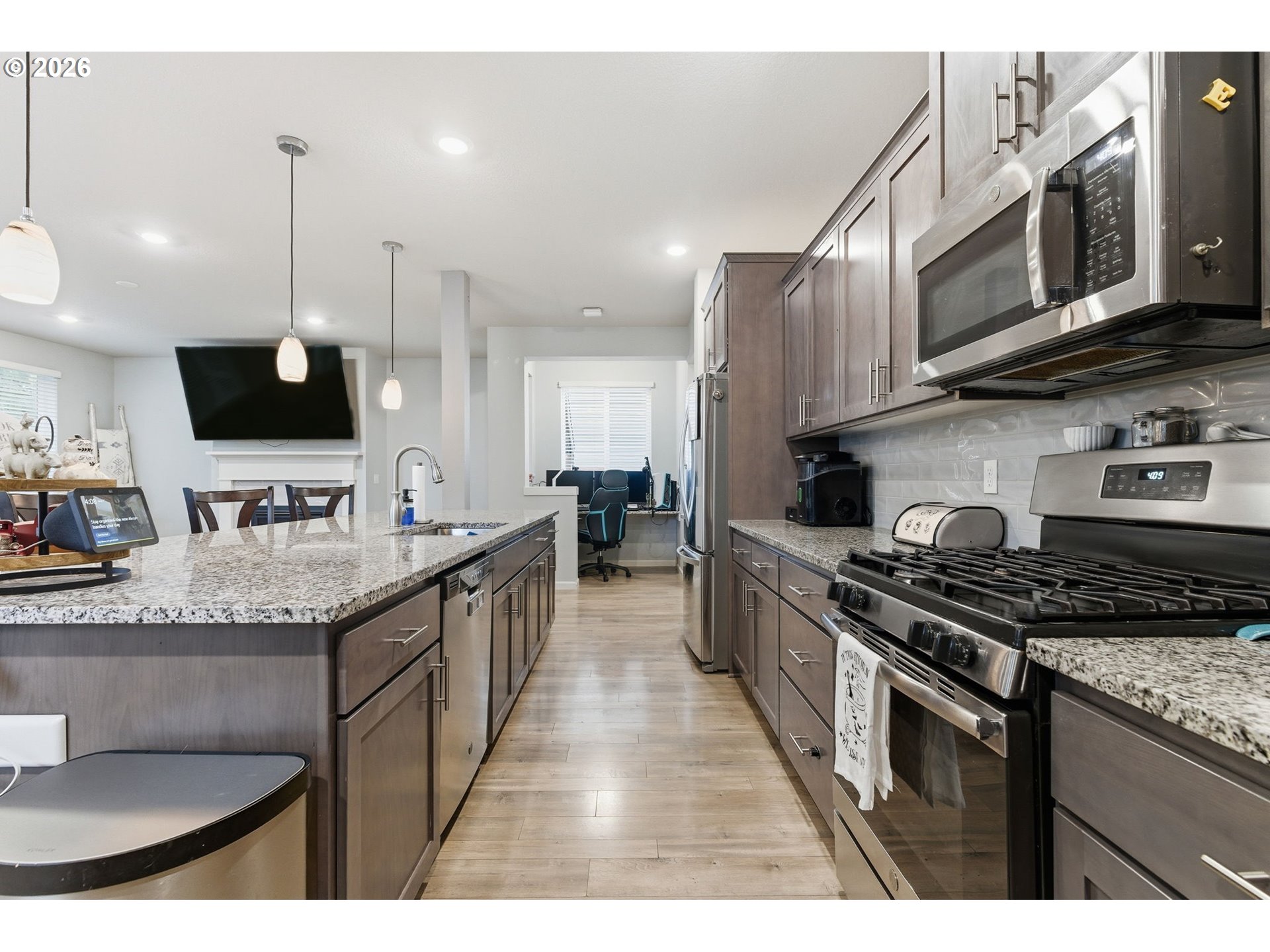 476 Southwest 15th Avenue Canby, OR 97013 - Photo 11 of 41 a kitchen with stainless steel appliances granite countertop a sink a stove top oven a counter space and cabinets