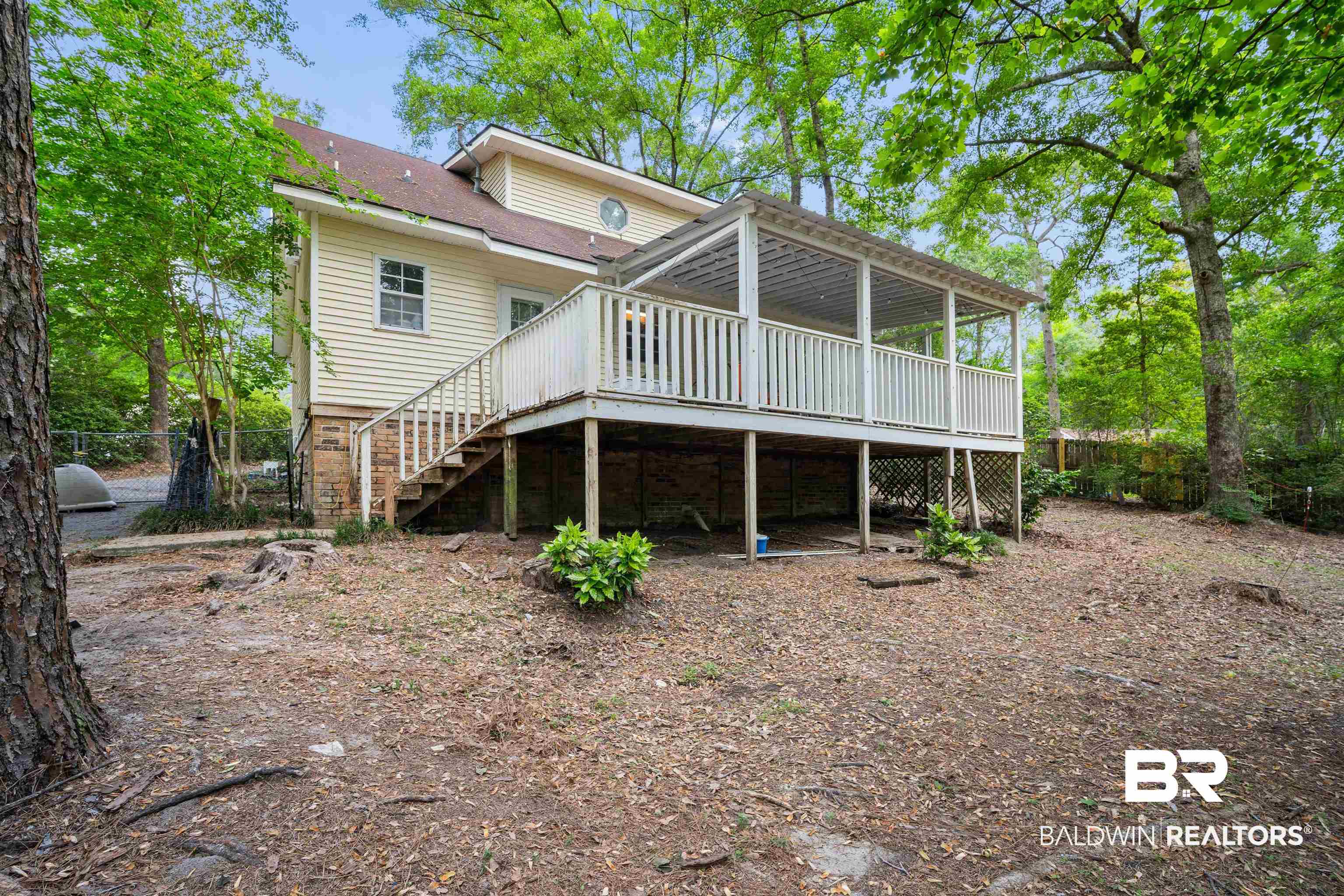 2823 Woodland Road Mobile, AL 36693 - Photo 24 of 29 Back of house with a wooden deck, stairway, and fence