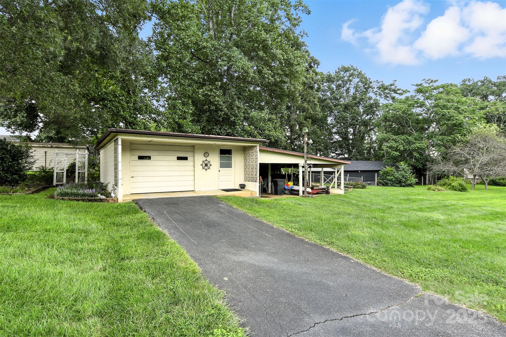 3968 Highway 321 Hudson, NC 28638 - Photo 16 of 47 a front view of a house with a yard and trees