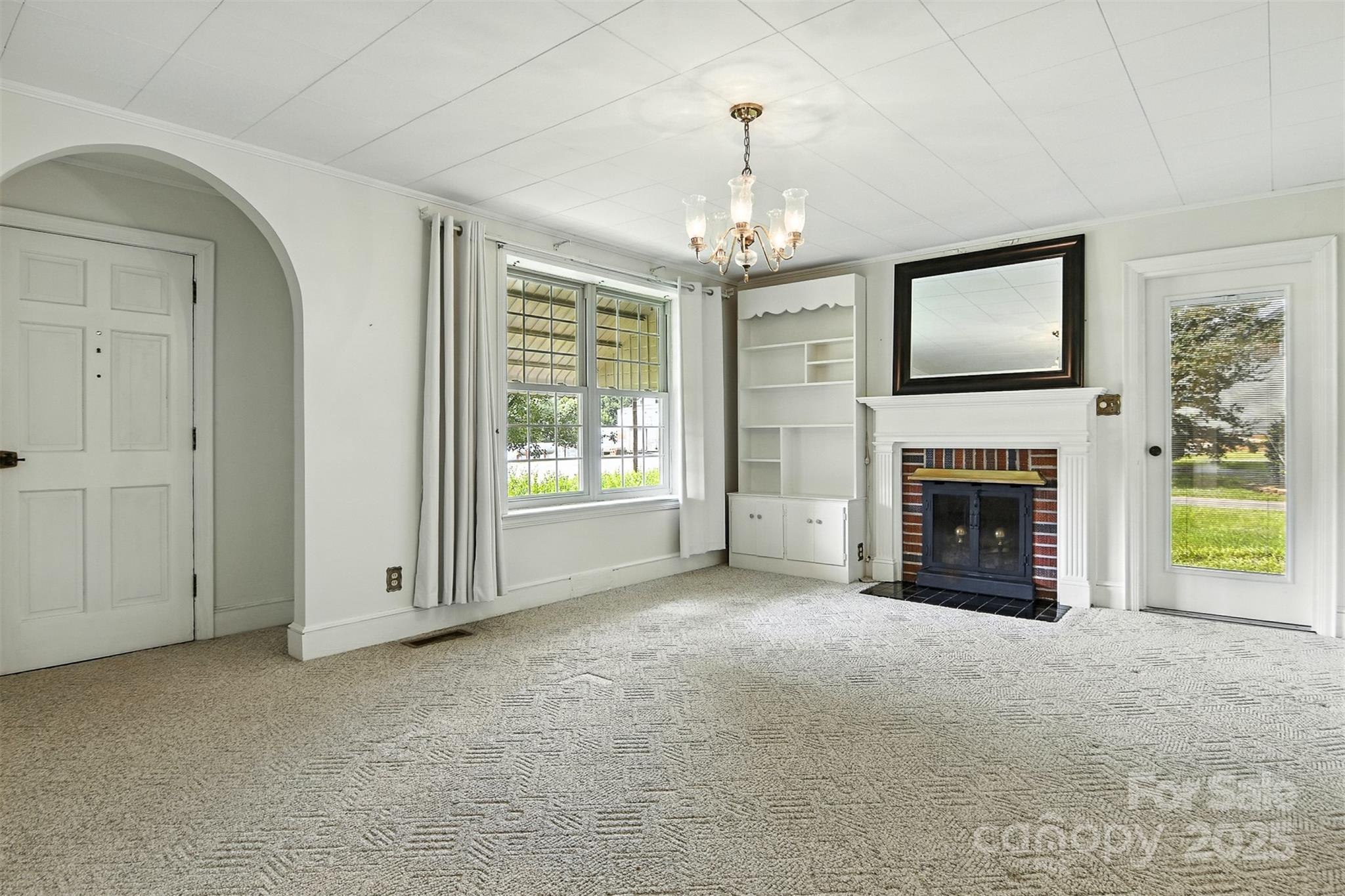 3968 Highway 321 Hudson, NC 28638 - Photo 2 of 47 a view of an empty room with a fireplace and a window