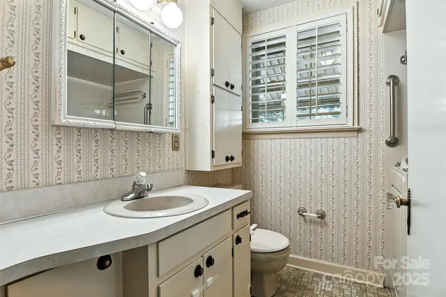 a view of an empty room with a fireplace and a window