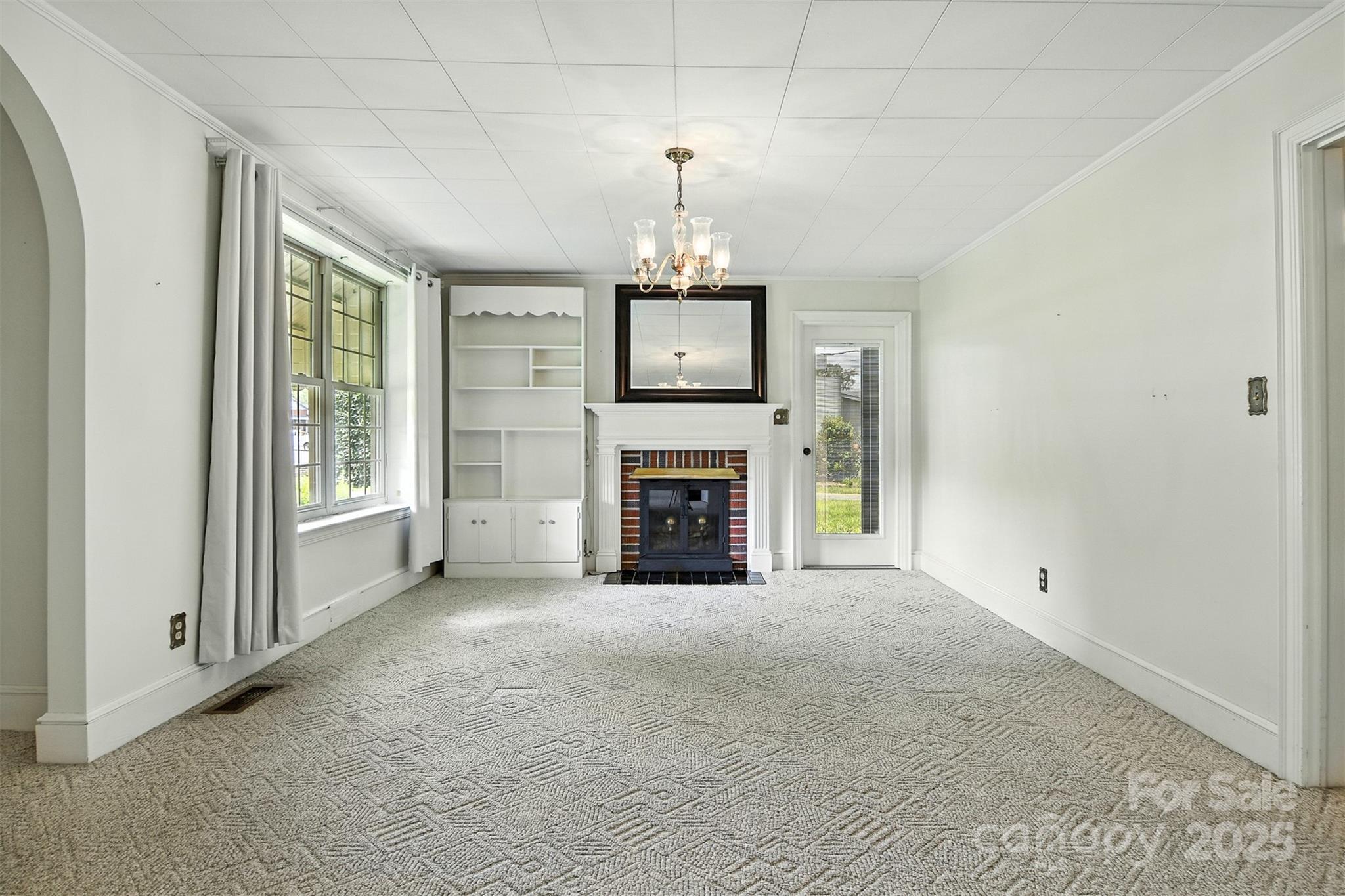 3968 Highway 321 Hudson, NC 28638 - Photo 26 of 47 a view of an empty room with a fireplace and a window