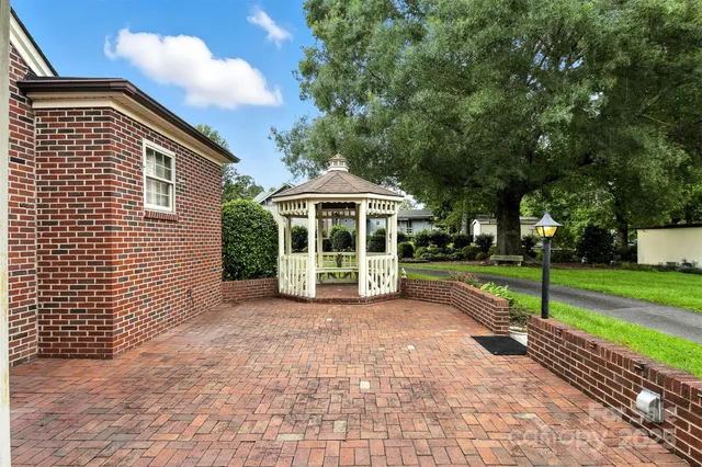 a front view of a house with a garden and plants