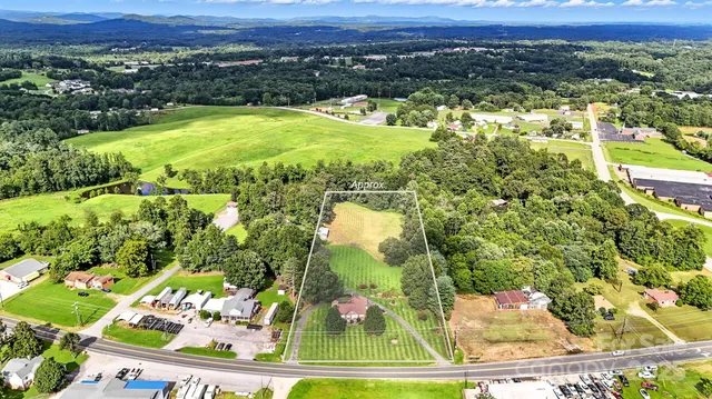 an aerial view of residential houses with outdoor space and swimming pool