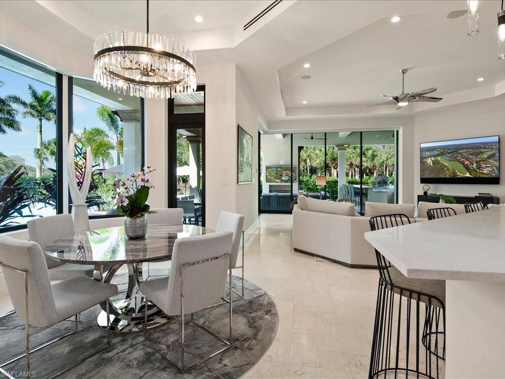 2581 Escada Drive Naples, FL 34109 - Photo 11 of 39 a dining room with furniture a chandelier and window