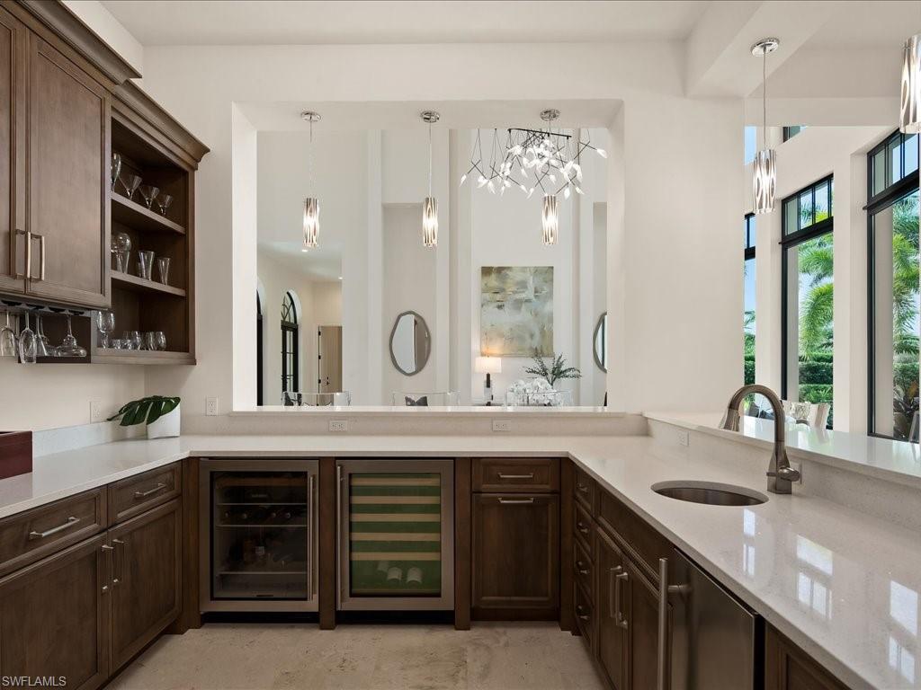 2581 Escada Drive Naples, FL 34109 - Photo 15 of 39 a kitchen with a sink and cabinets