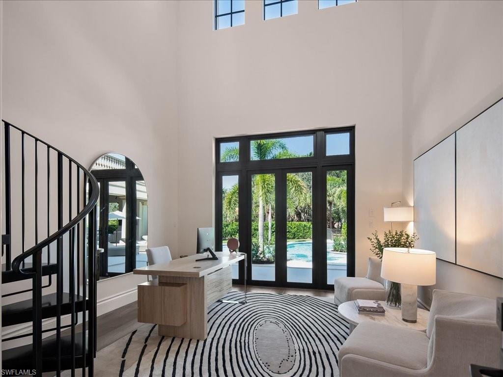2581 Escada Drive Naples, FL 34109 - Photo 16 of 39 a living room with furniture a table and a large window
