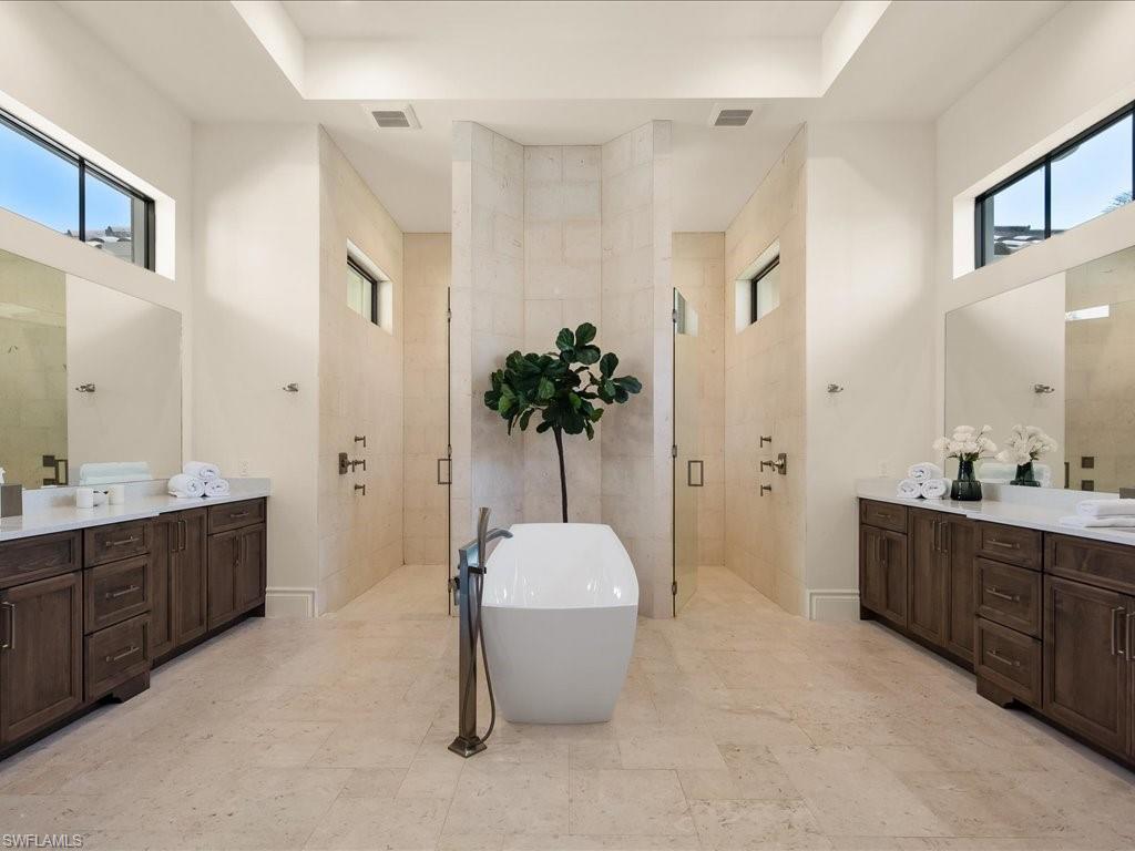 2581 Escada Drive Naples, FL 34109 - Photo 21 of 39 a bathroom with a tub sink and mirror