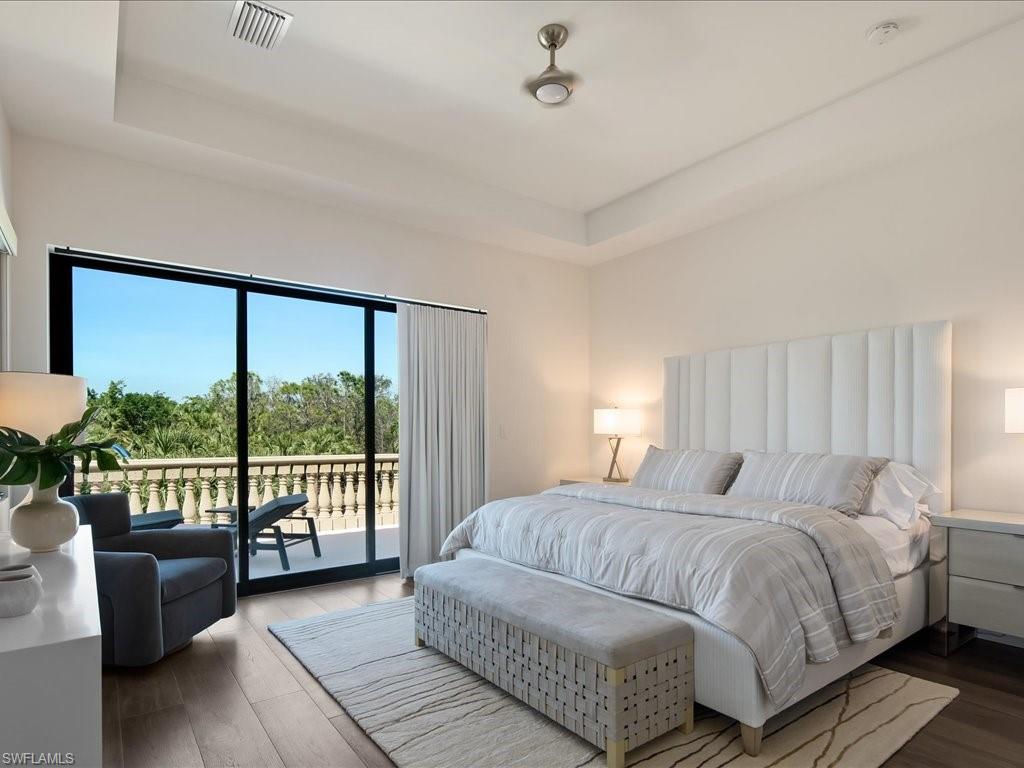 2581 Escada Drive Naples, FL 34109 - Photo 28 of 39 a bedroom with a large bed and a large window