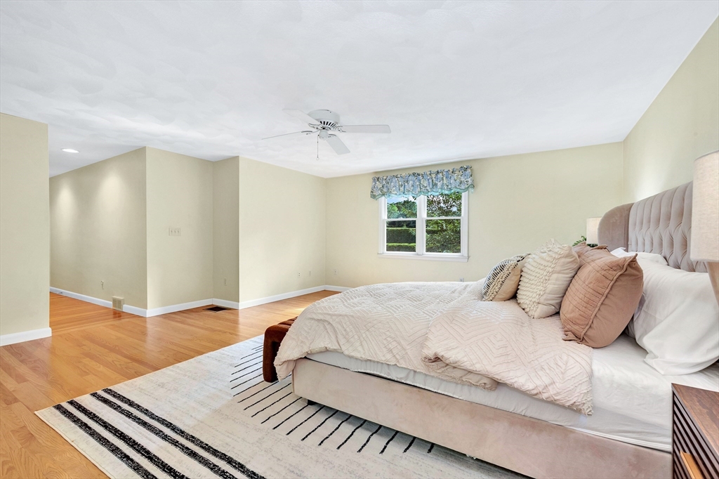 443 A North Road Bedford, MA 01730 - Photo 16 of 36 a bedroom with a bed and wooden floor