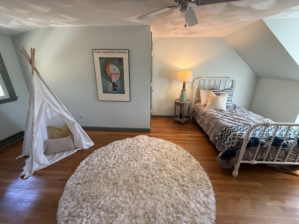 443 A North Road Bedford, MA 01730 - Photo 24 of 36 a bedroom with a bed lamp and wooden floor