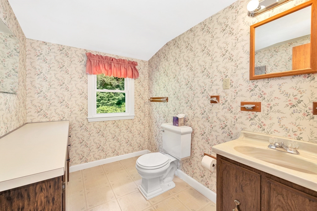 443 A North Road Bedford, MA 01730 - Photo 27 of 36 a bathroom with a granite countertop toilet a sink and a bathtub