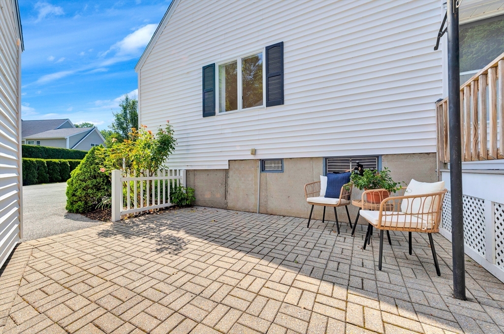 443 A North Road Bedford, MA 01730 - Photo 29 of 36 a view of a porch with a chairs and table in a patio