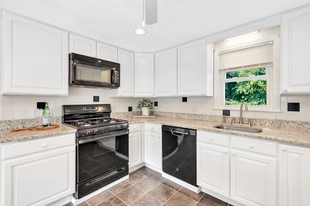 443 A North Road Bedford, MA 01730 - Photo 6 of 36 a kitchen with cabinets stainless steel appliances a sink and a window