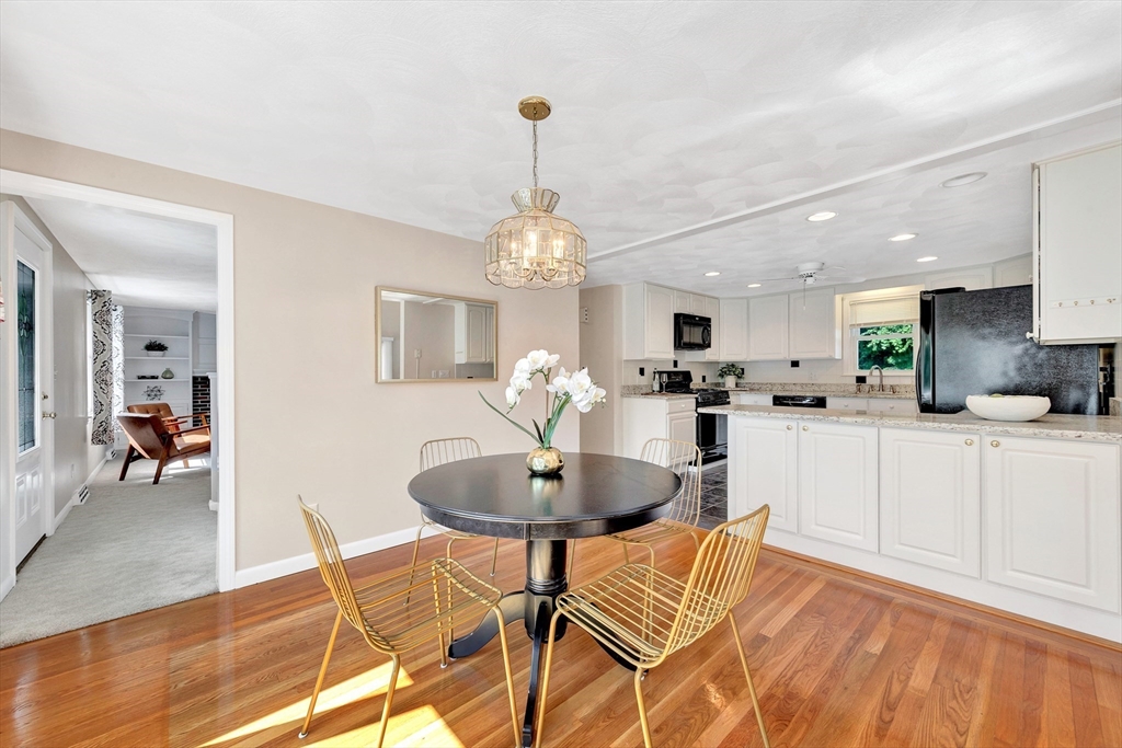 443 A North Road Bedford, MA 01730 - Photo 7 of 36 a kitchen with stainless steel appliances kitchen island granite countertop a table and chairs in it