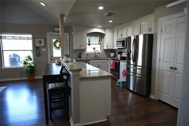 a kitchen with refrigerator and window