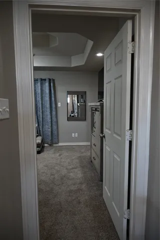 a view of a hallway with wooden shelves