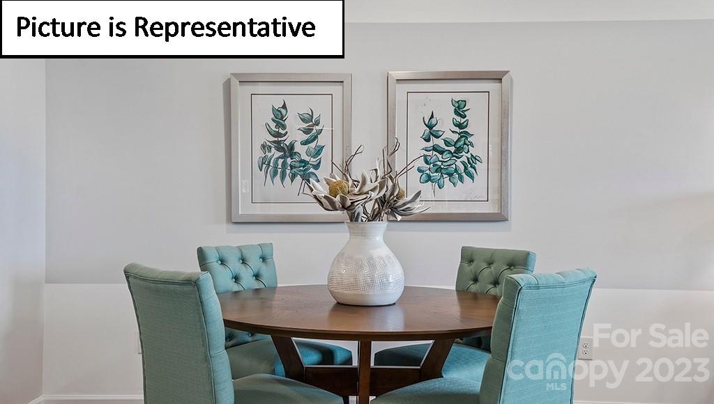 9027 Lowfalls Lane Charlotte, NC 28216 - Photo 12 of 27 a view of a dining room with furniture and wooden floor