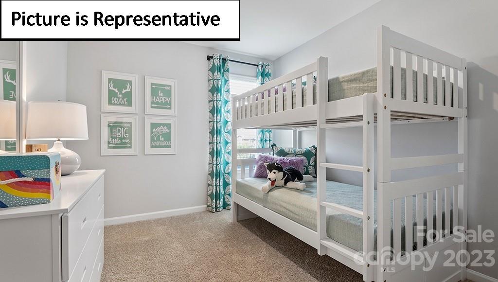 9027 Lowfalls Lane Charlotte, NC 28216 - Photo 21 of 27 a bedroom with furniture and a window